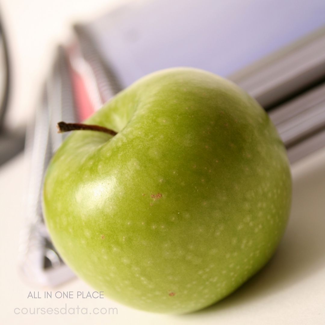 Green apple on a desk.