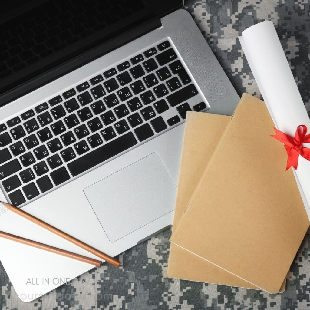 Laptop with stationery and papers.