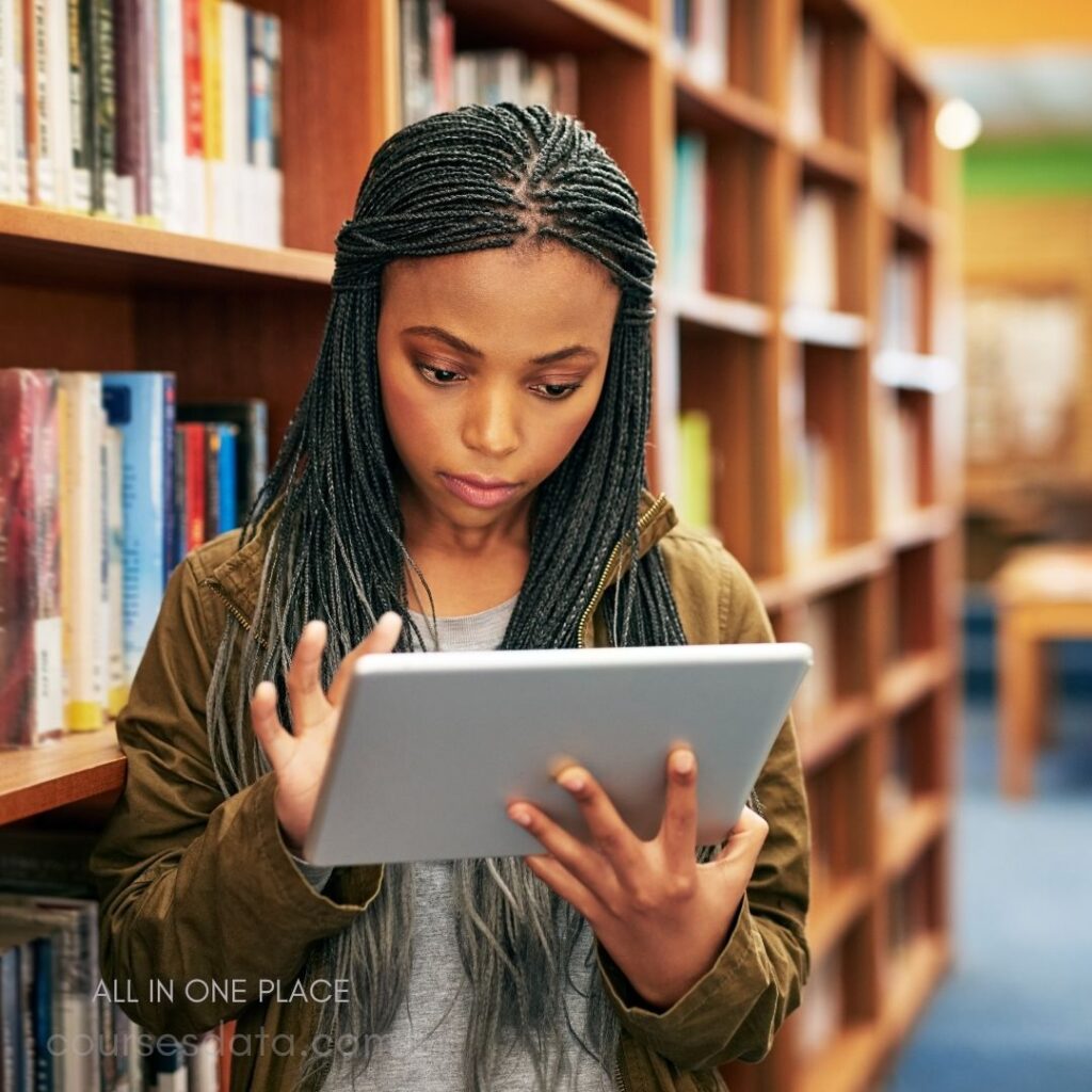 Young woman using tablet, library.