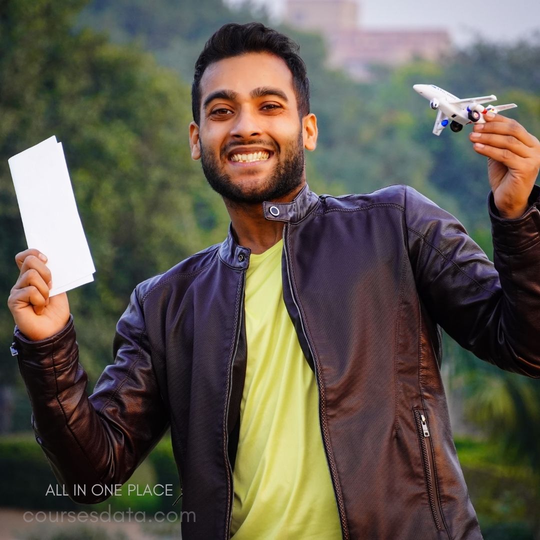 Smiling man holding airplane model.