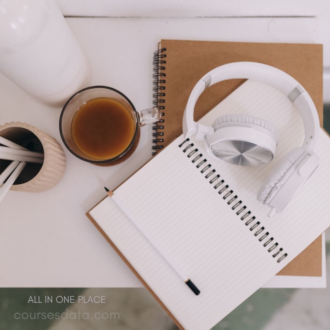 Coffee, headphones, notebook, pens.