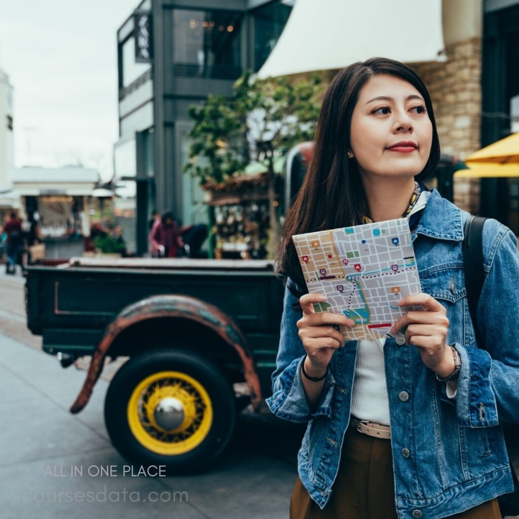 Woman holding map outdoors.