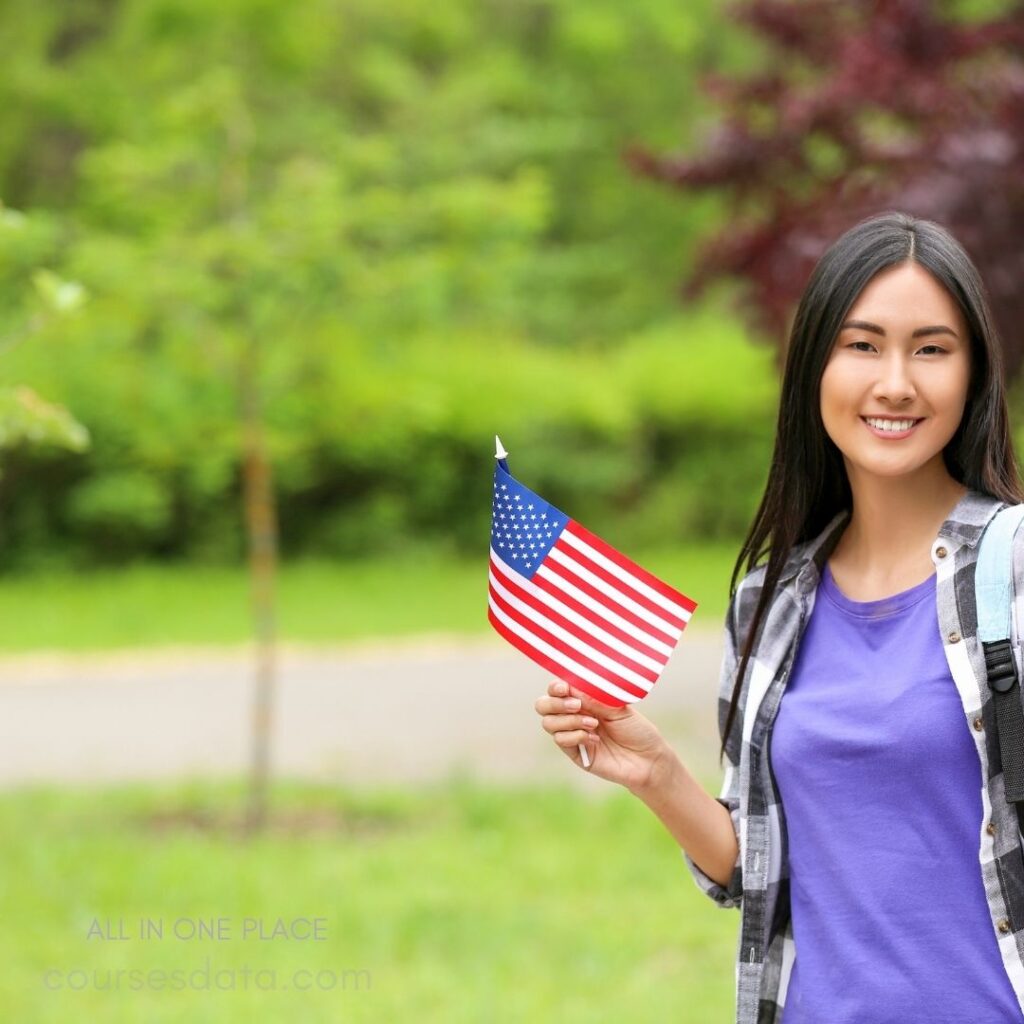 Smiling woman holding American flag.