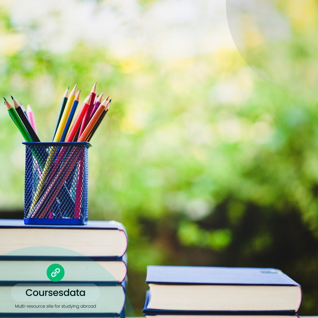 Colored pencils in holder, books.