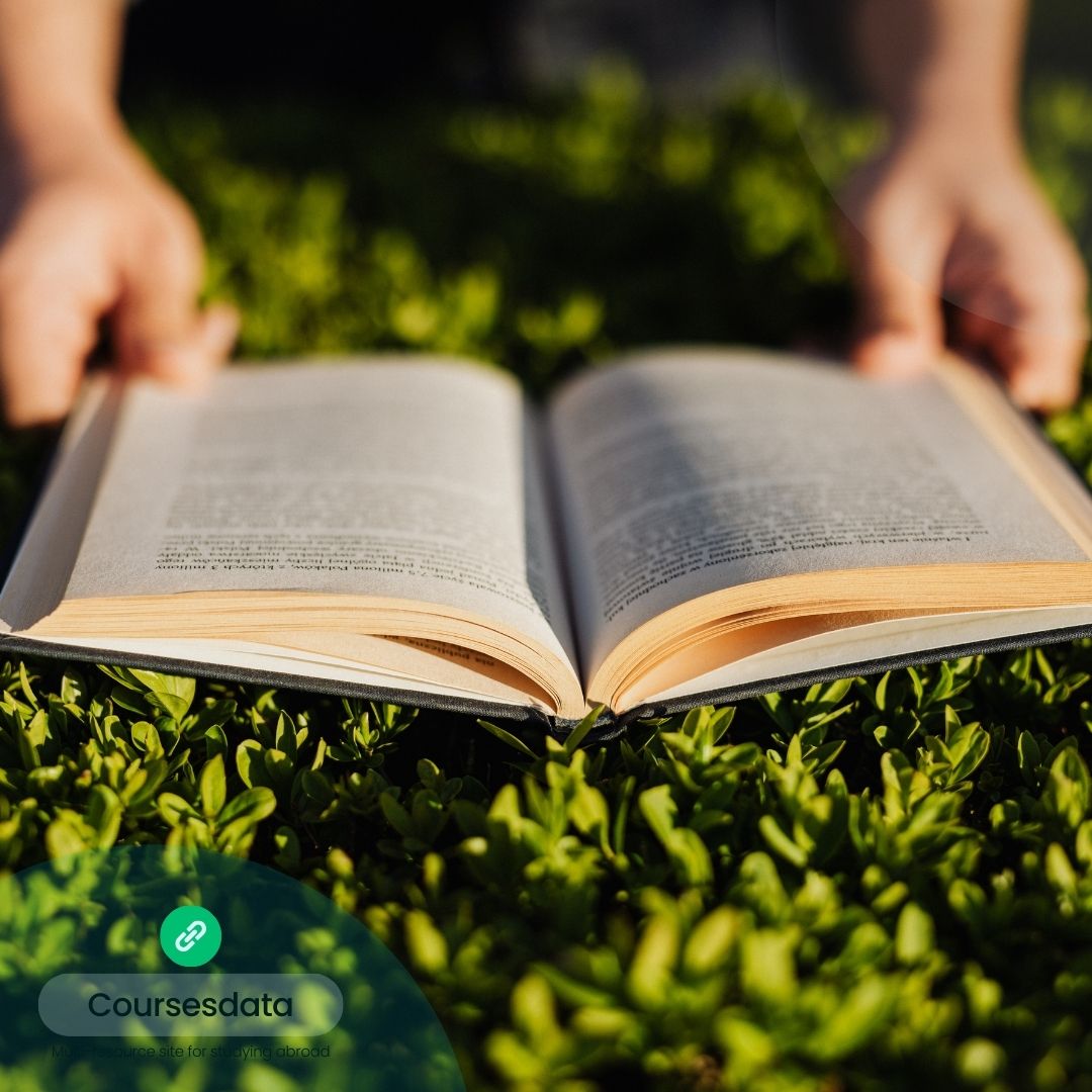 Open book resting on grass.