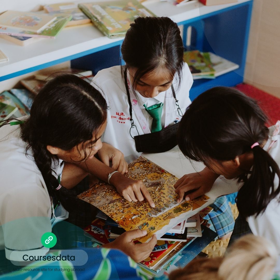 Children studying together over books.