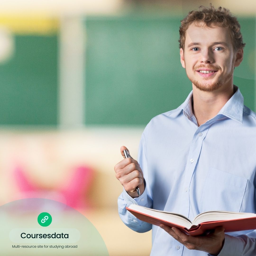 Smiling man holding book and pen.