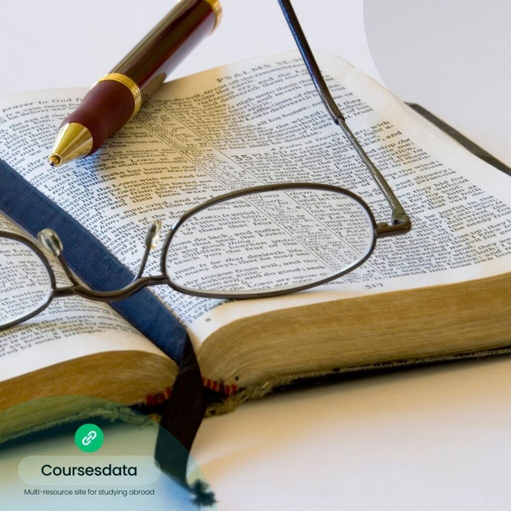 Open Bible with glasses and pen.