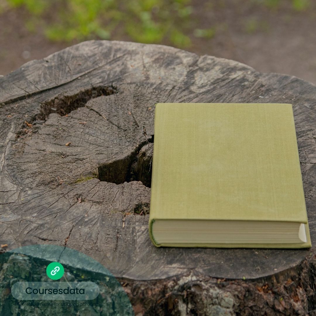 Green book on wooden stump.