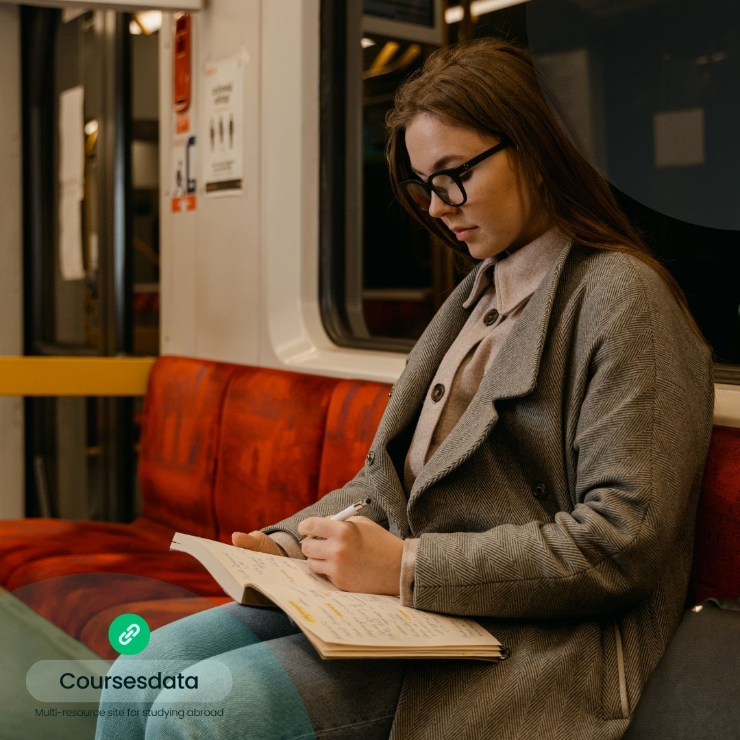 Woman writing in notebook, subway.