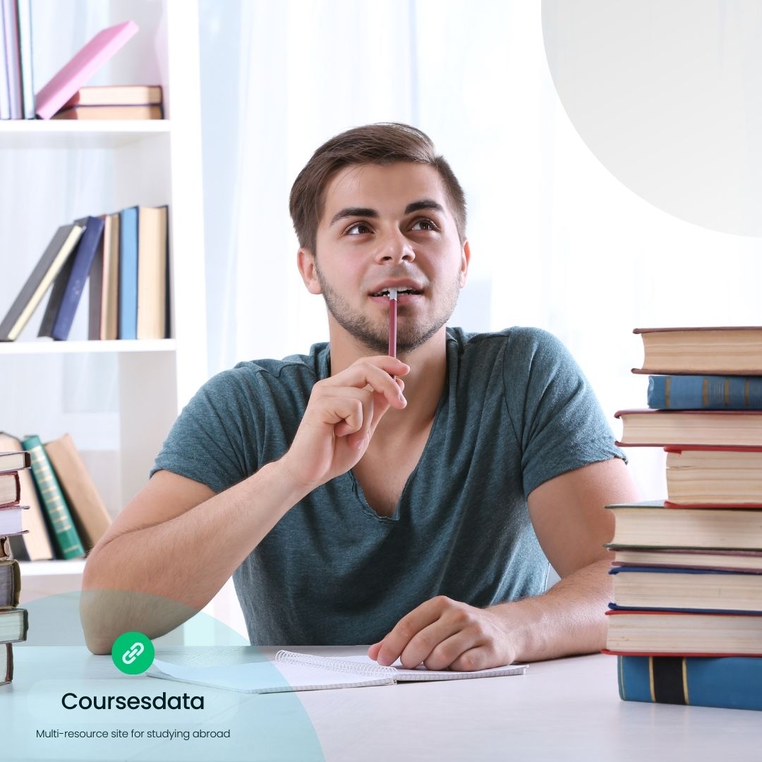 Student pondering with books nearby.