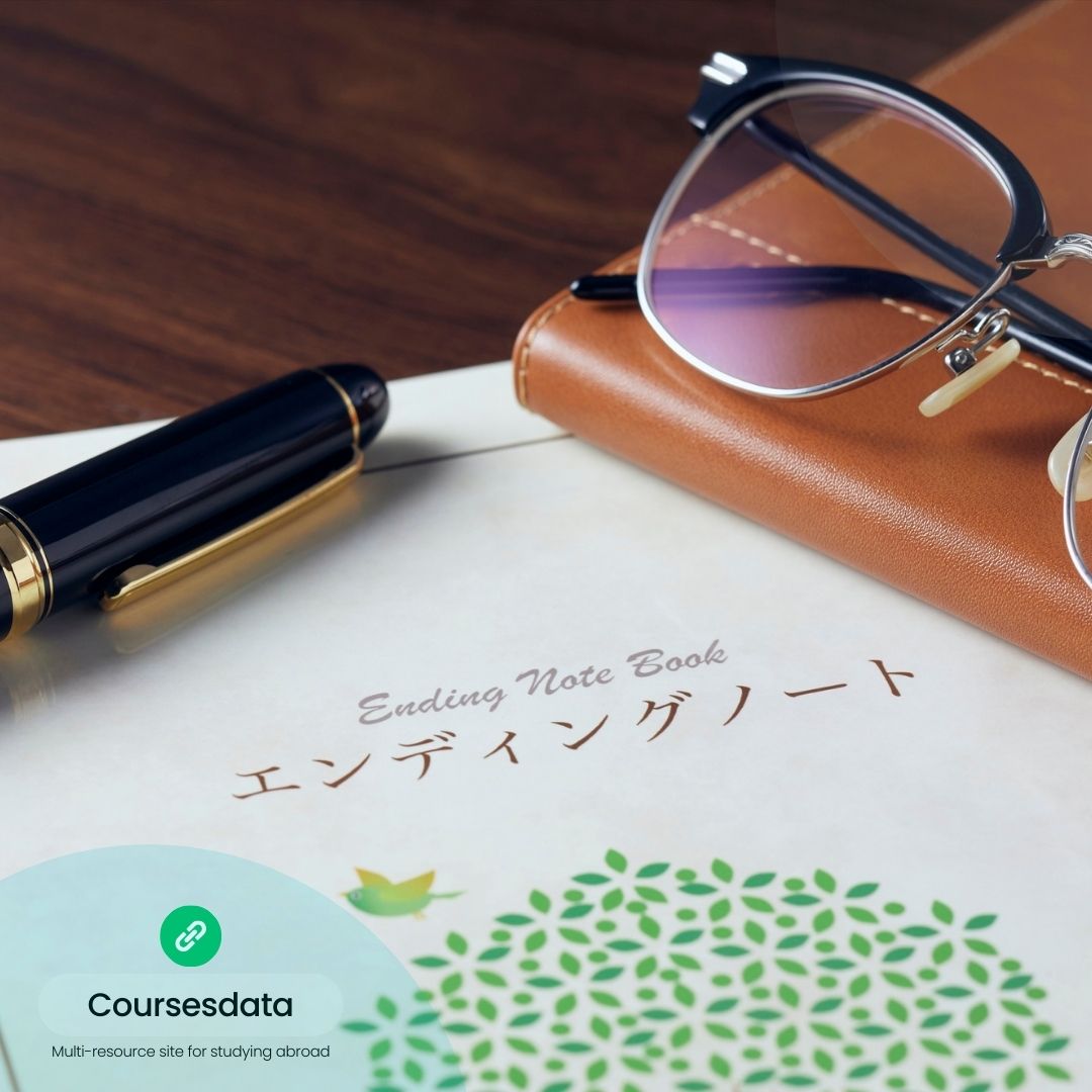 Notebook, glasses, pen on table.