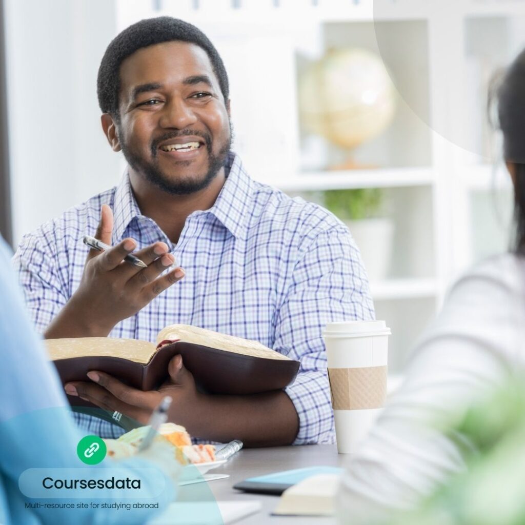 Smiling man discussing with group.