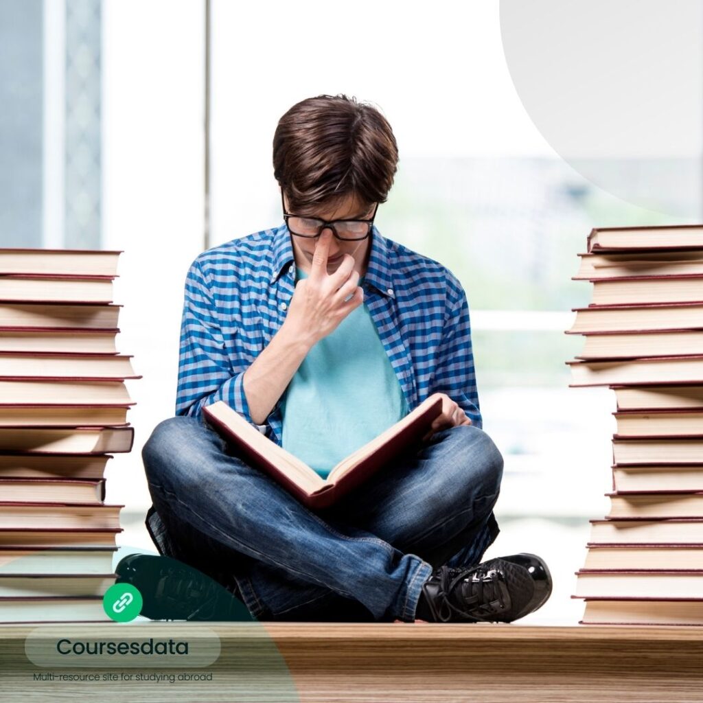 Student reading book, thoughtful expression.