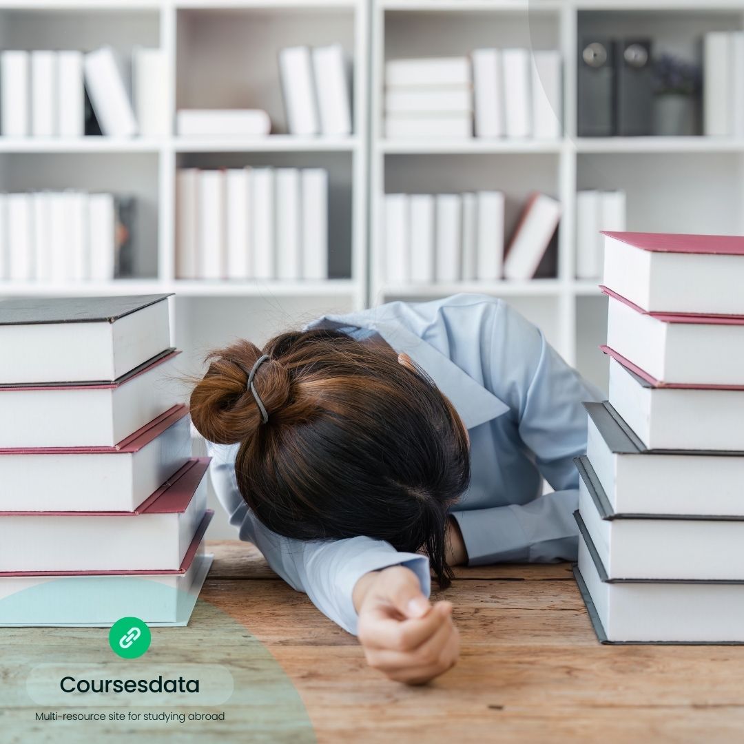 Stressed student surrounded by books.