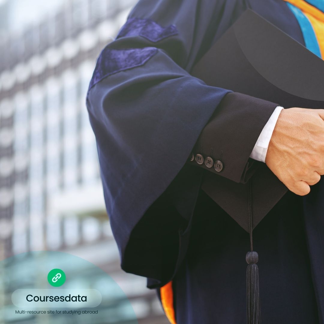 Graduate holding diploma outdoors.