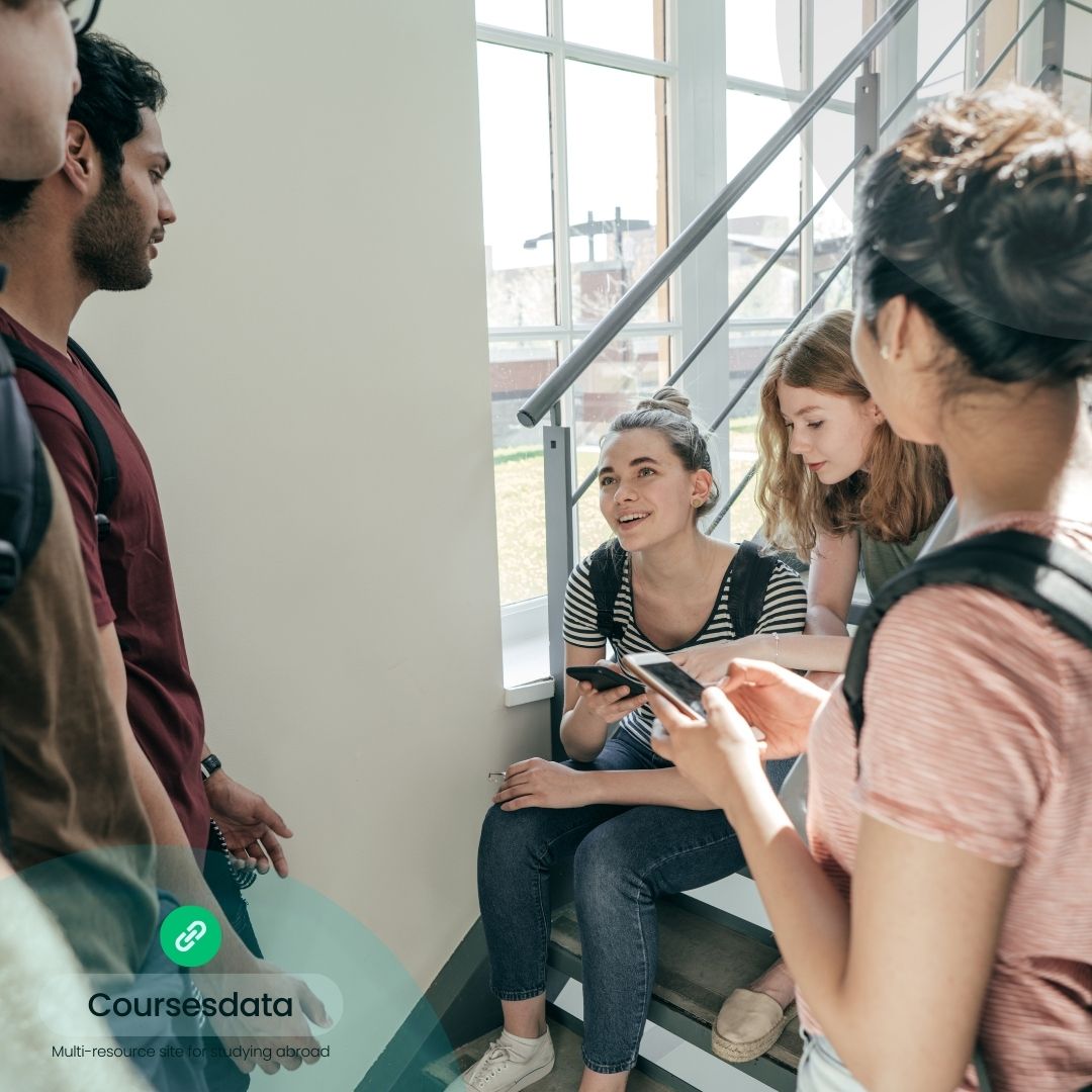 Students chatting on staircase.