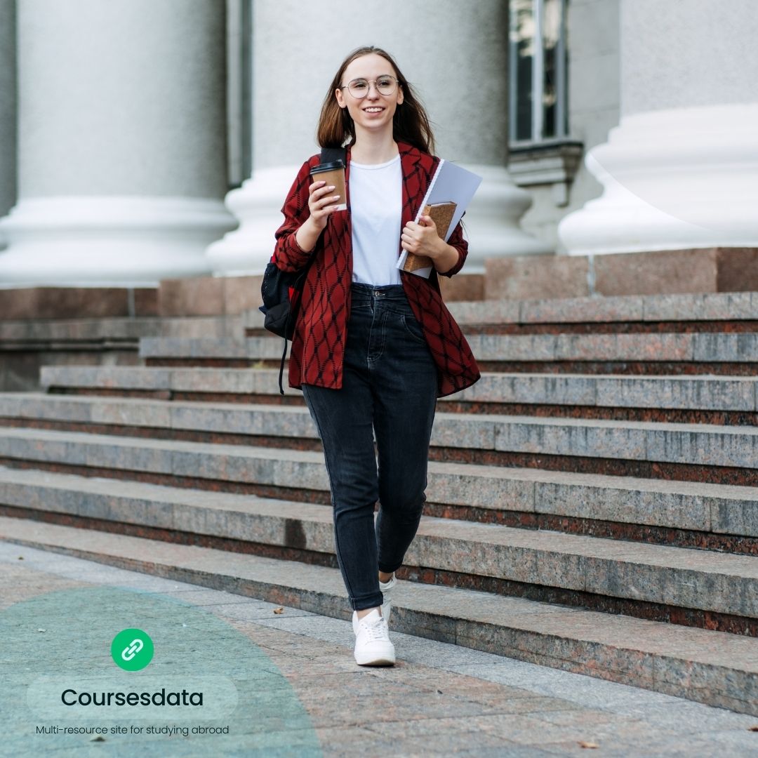 Student walking with coffee and books.