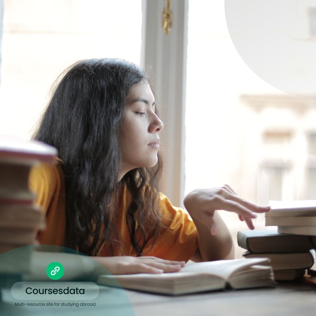 Woman studying by window.