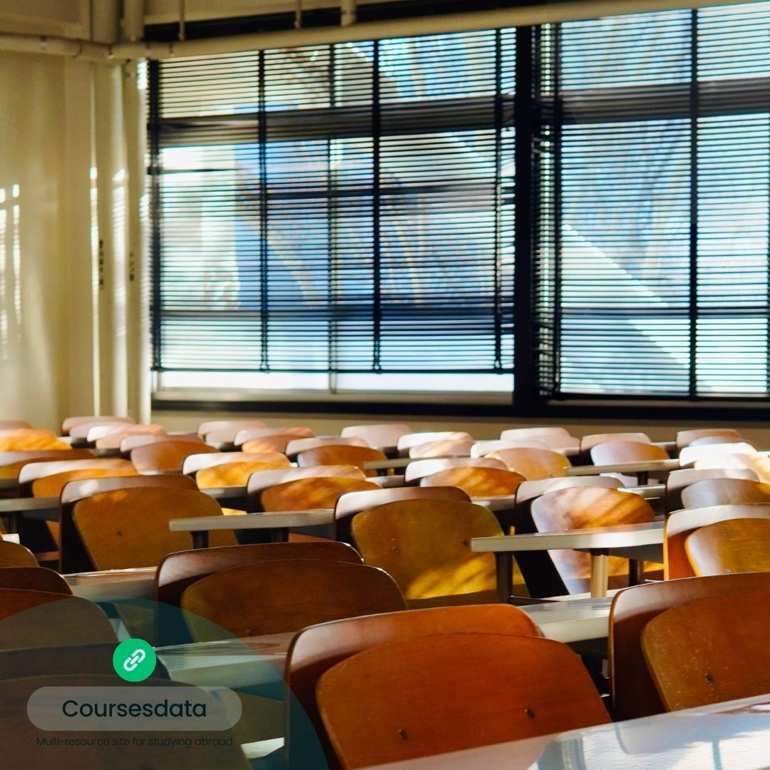 Sunlit empty classroom with desks.