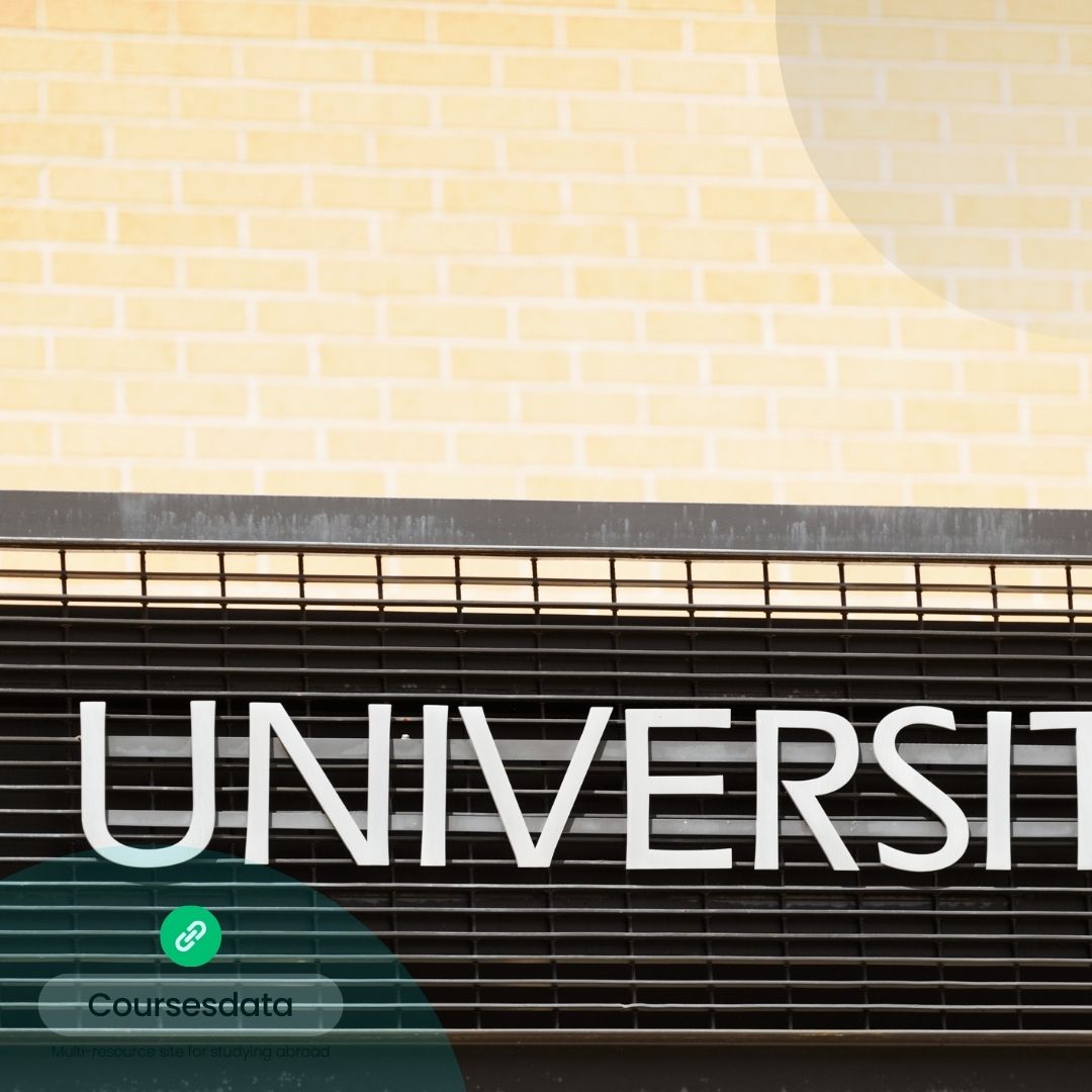 University sign on brick wall.