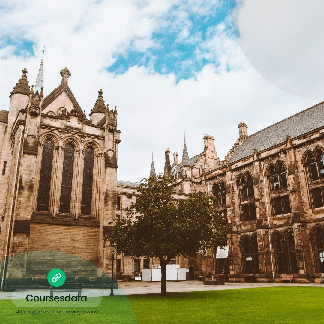 Historic university buildings under clouds.