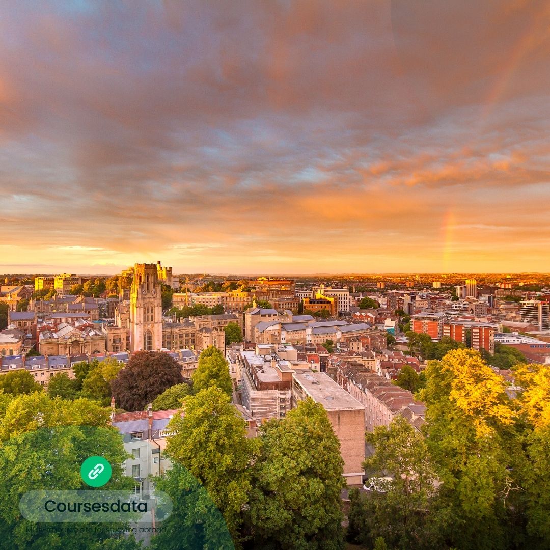 Sunset over city skyline, rainbow.