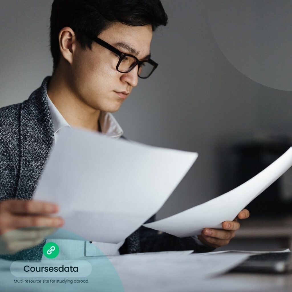 Young man reading documents attentively.