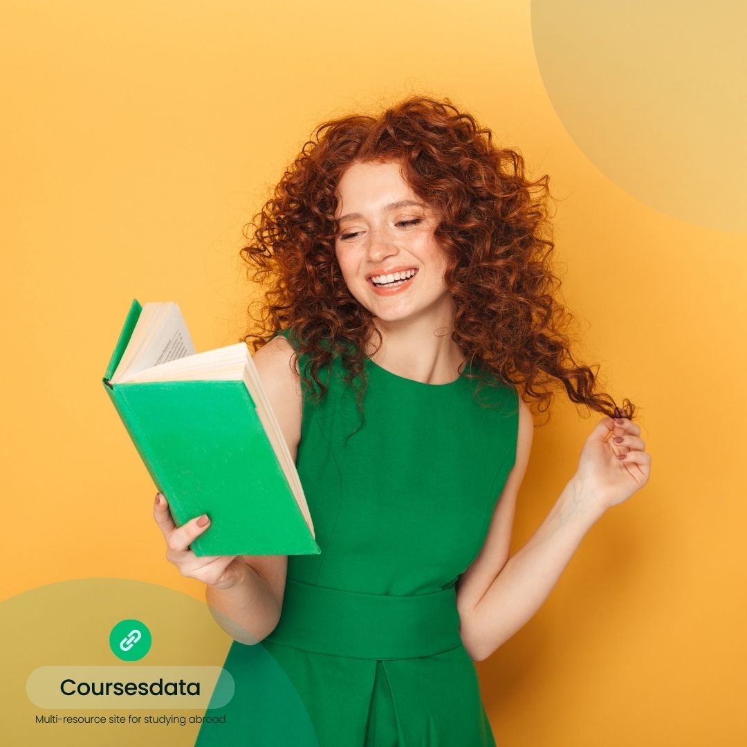 Smiling girl reading green book.