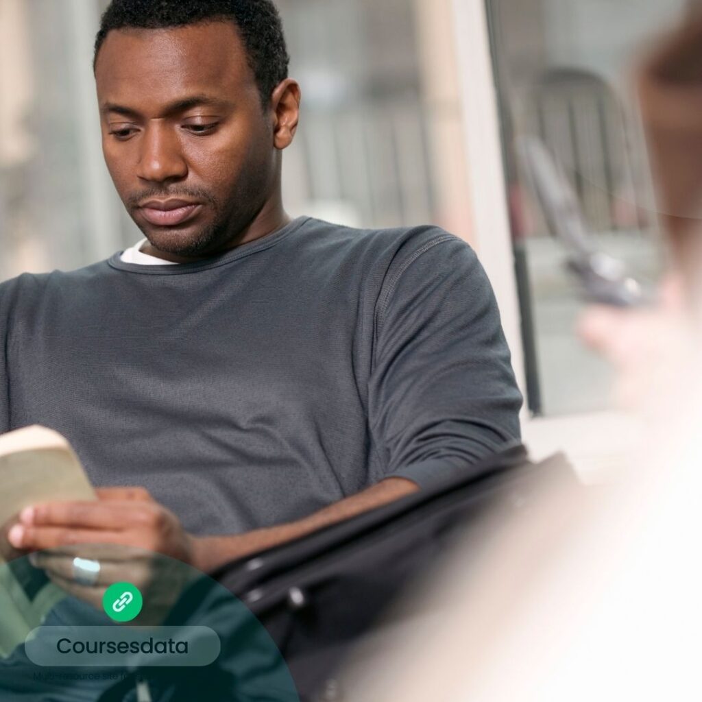 Man reading book indoors.