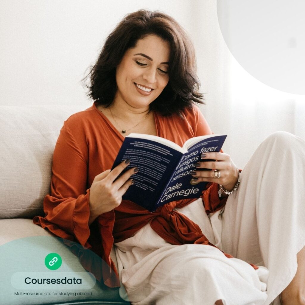 Woman reading book, smiling.