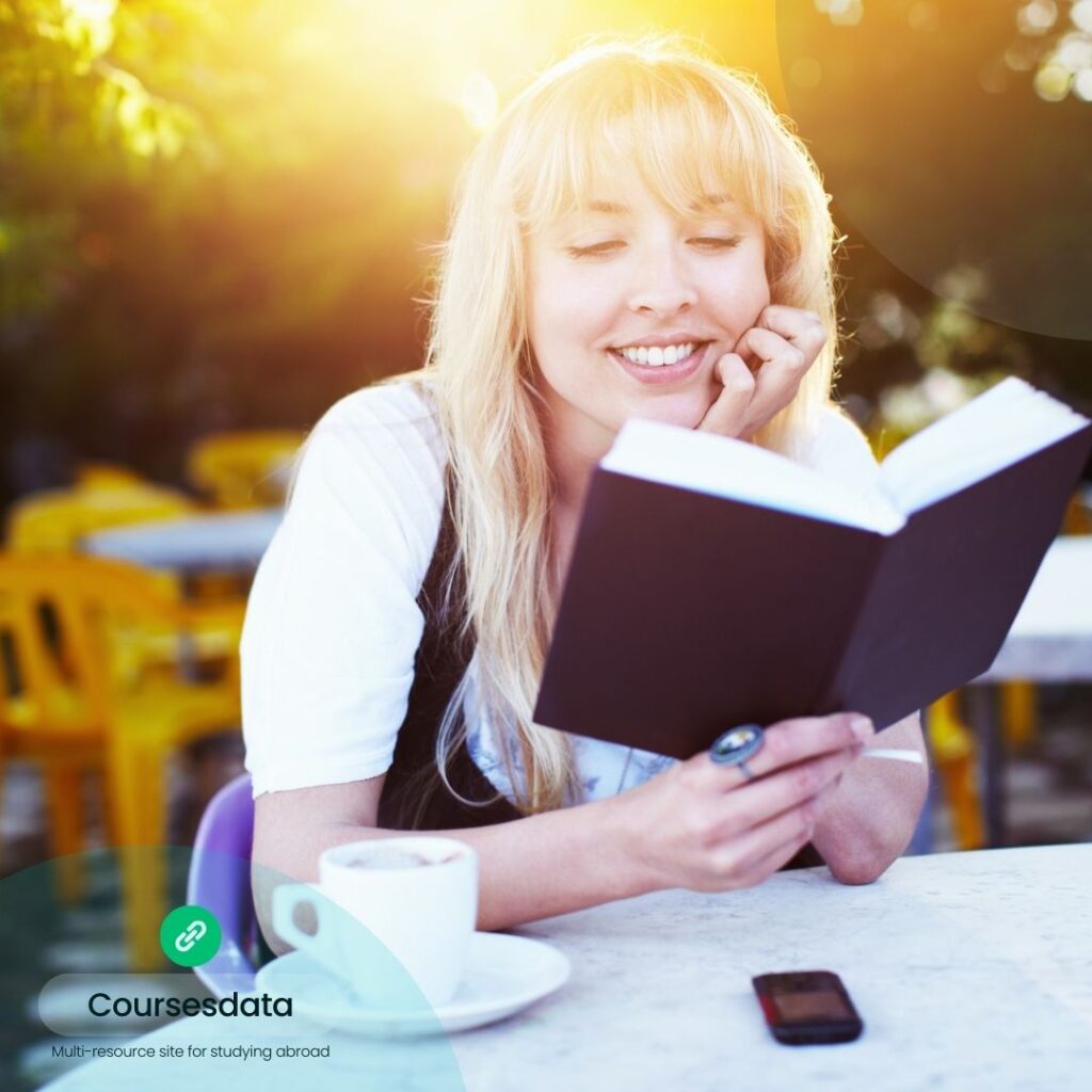 Smiling woman reading book outdoors.