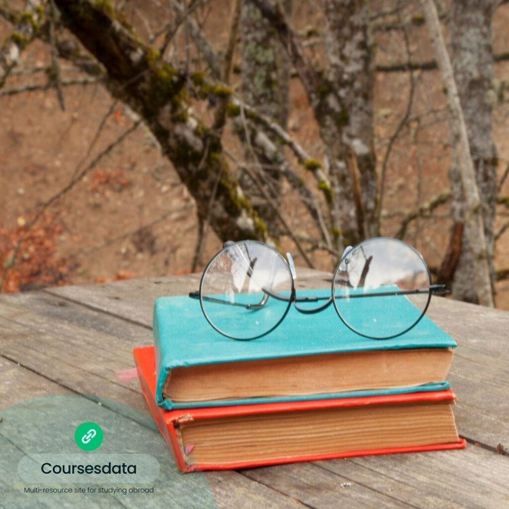 Books with glasses outdoors.