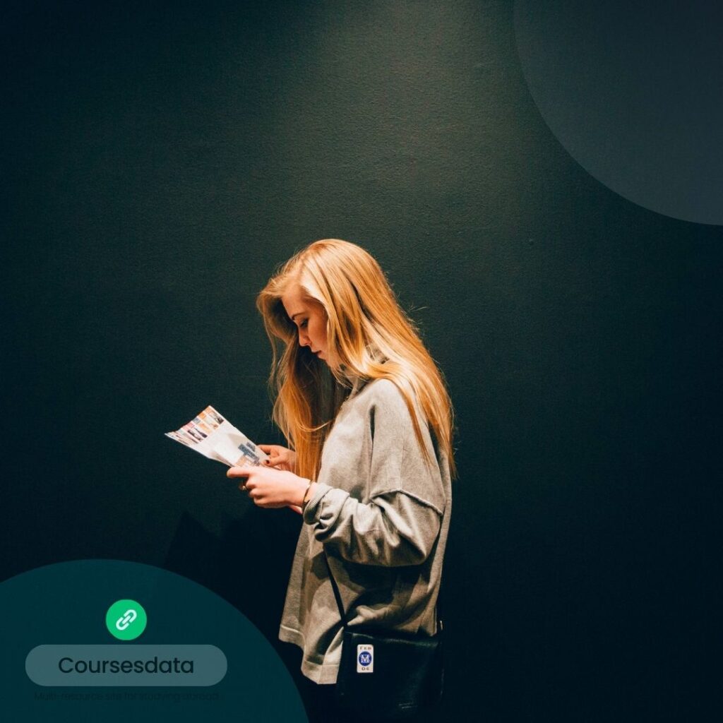 Woman reading a pamphlet, side profile.