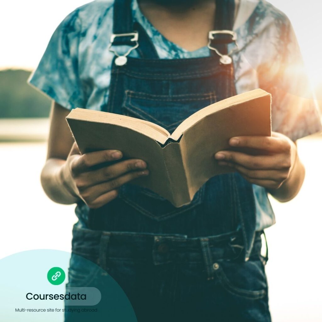 Person reading a book outdoors.