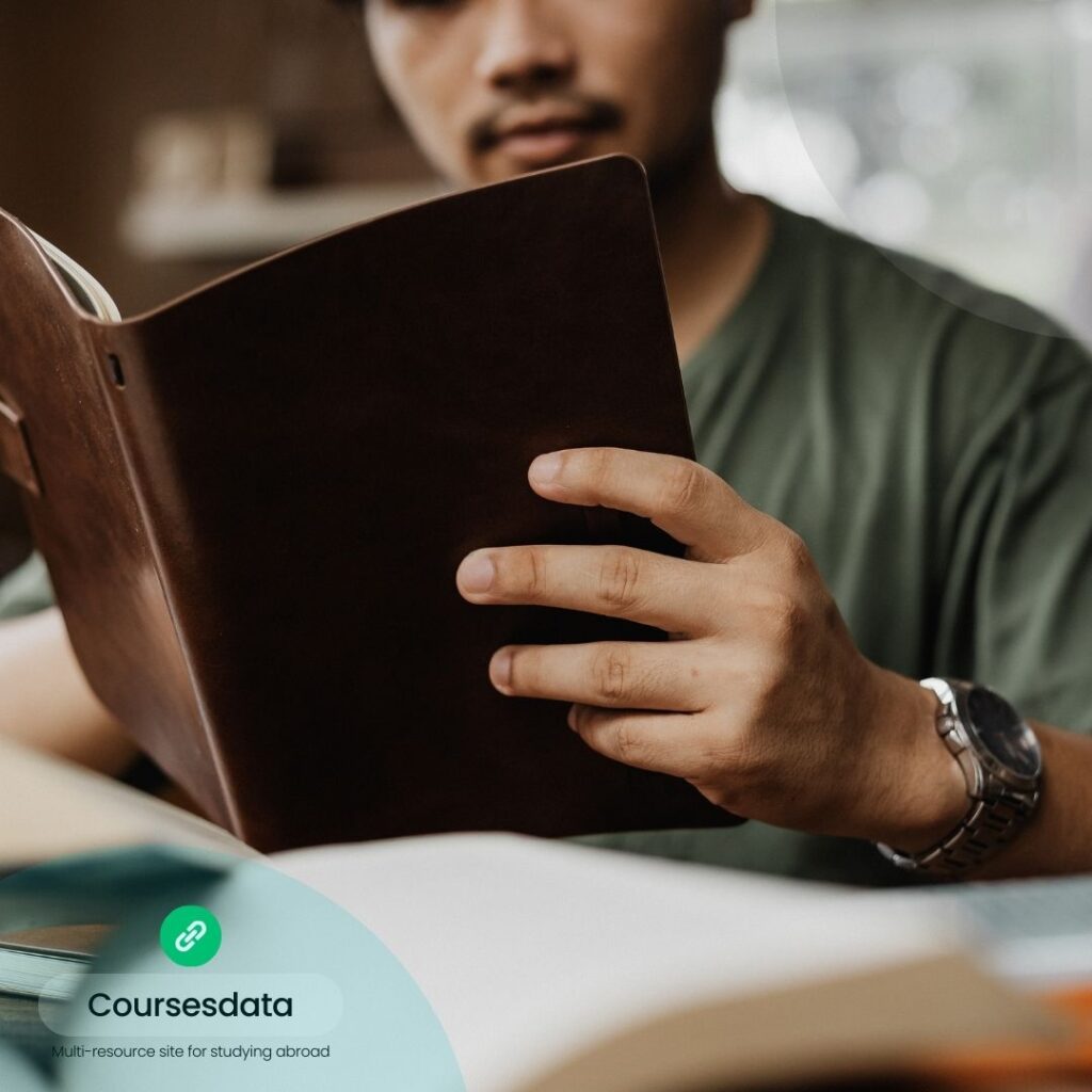 Person reading a brown notebook.