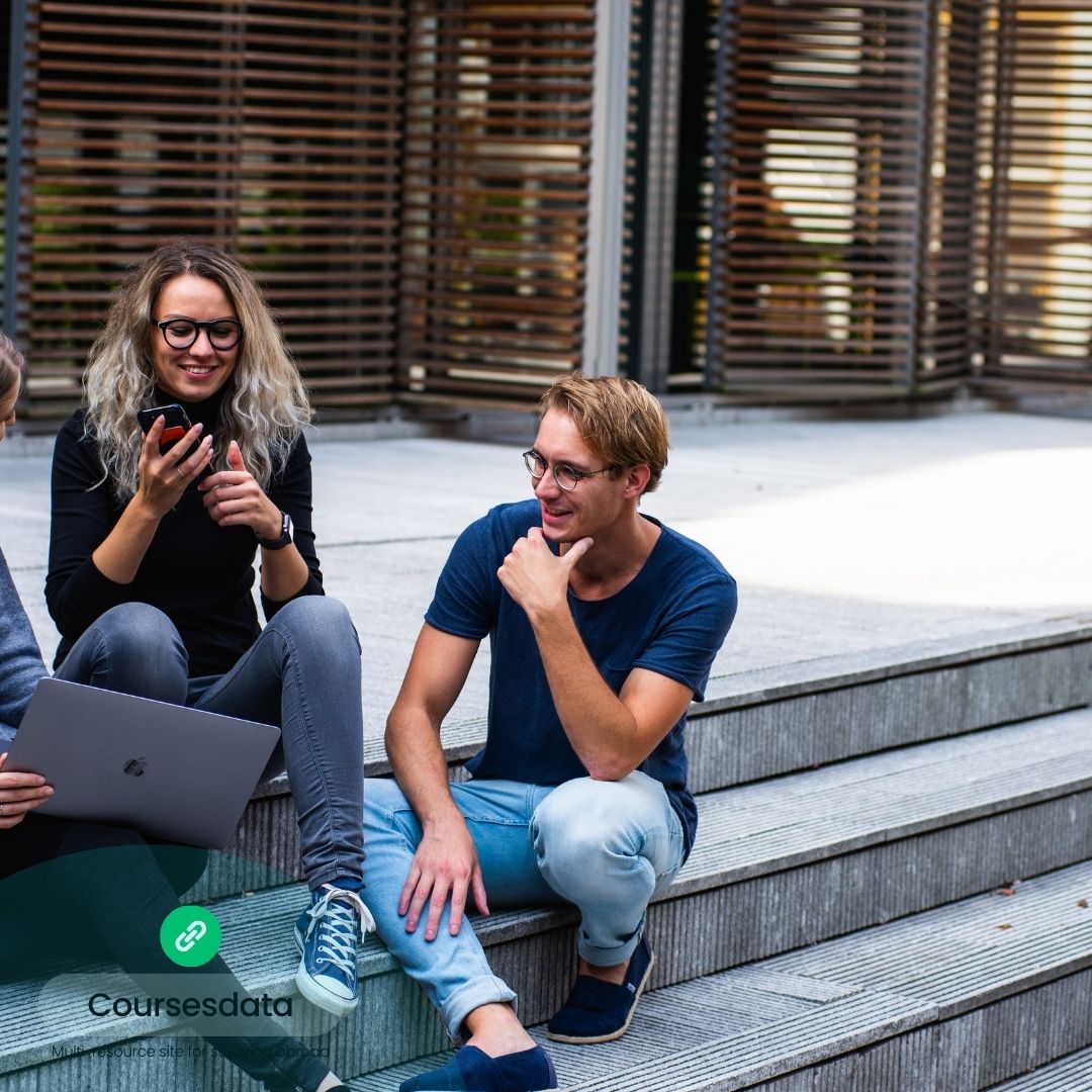 Group collaborating outdoors on steps.