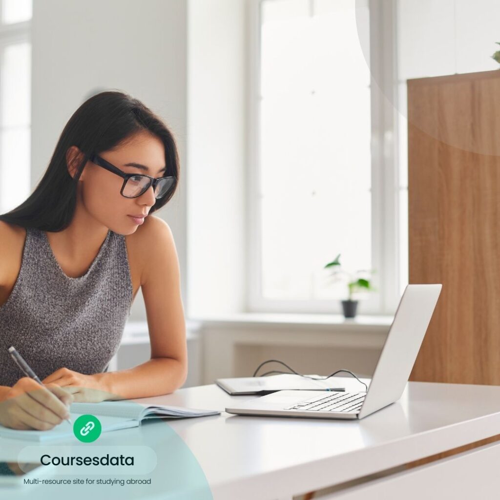 Woman studying at desk.