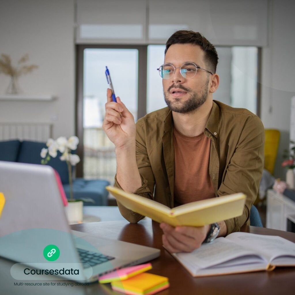 Man studying with notebook, pondering.