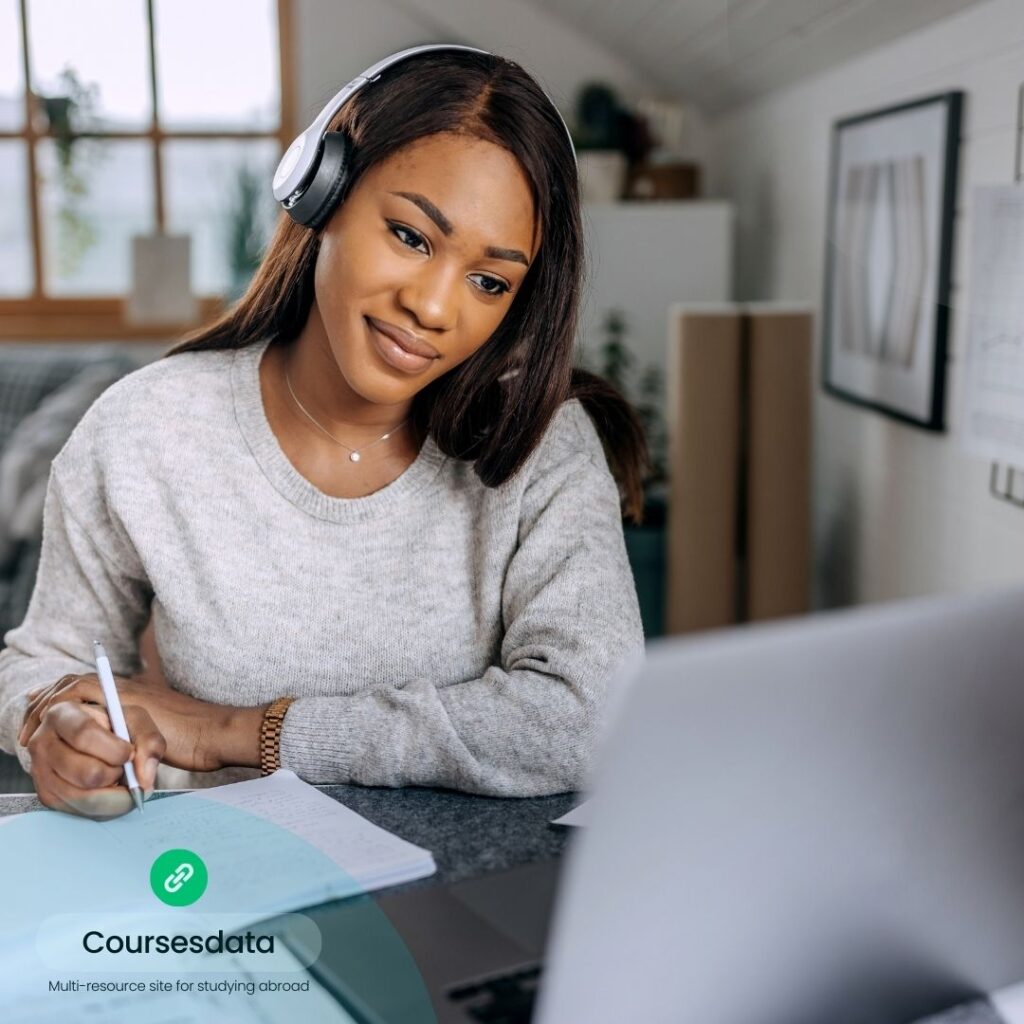 Woman studying with headphones on.