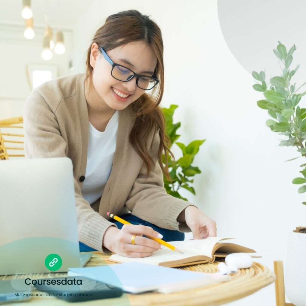 Smiling woman studying at home.