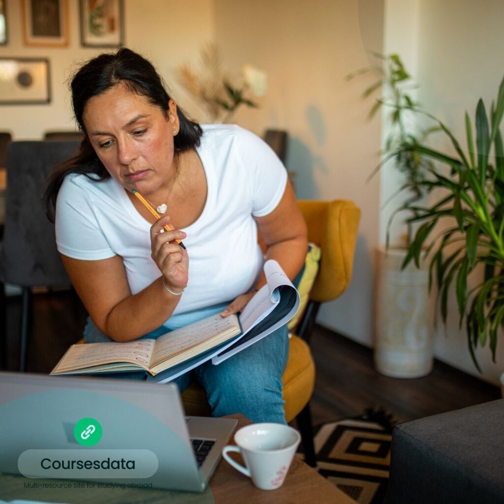 Woman studying with laptop, notebook.