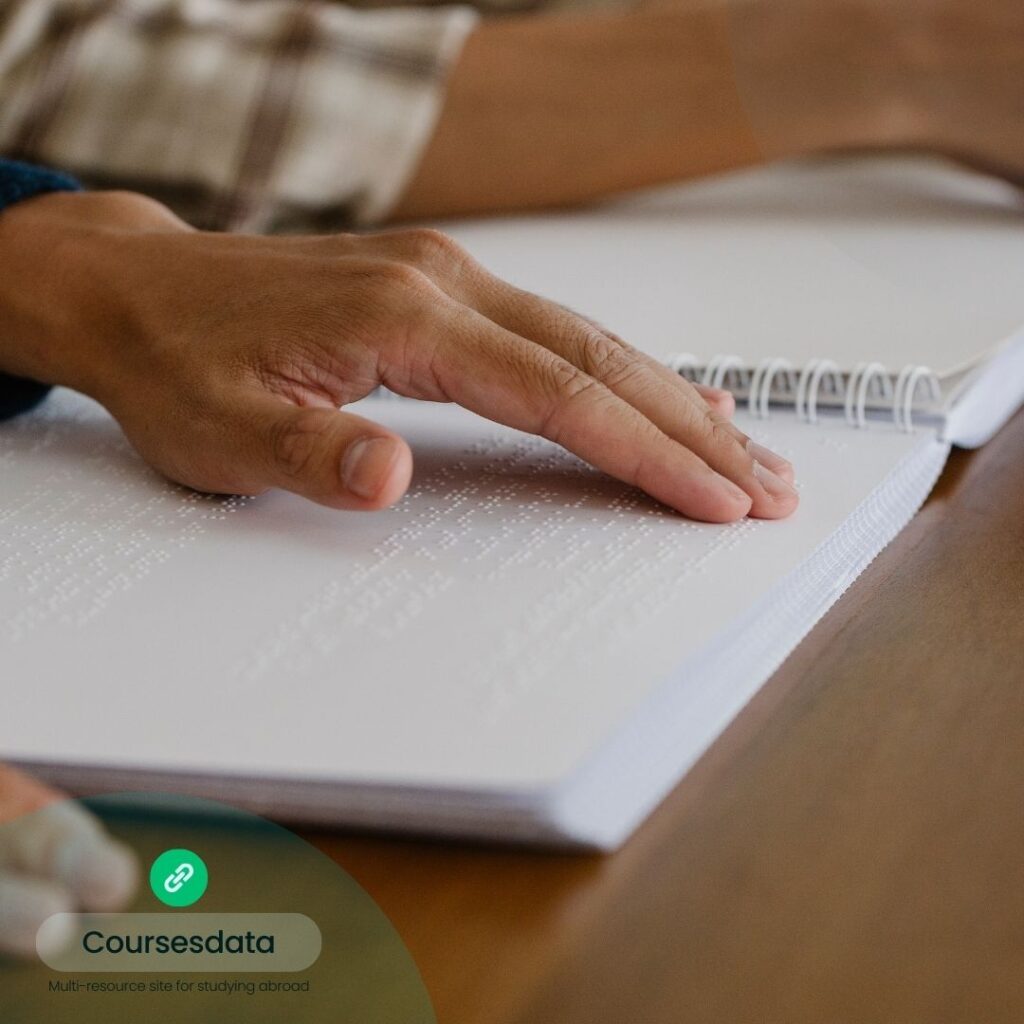 Hand reading Braille on paper.