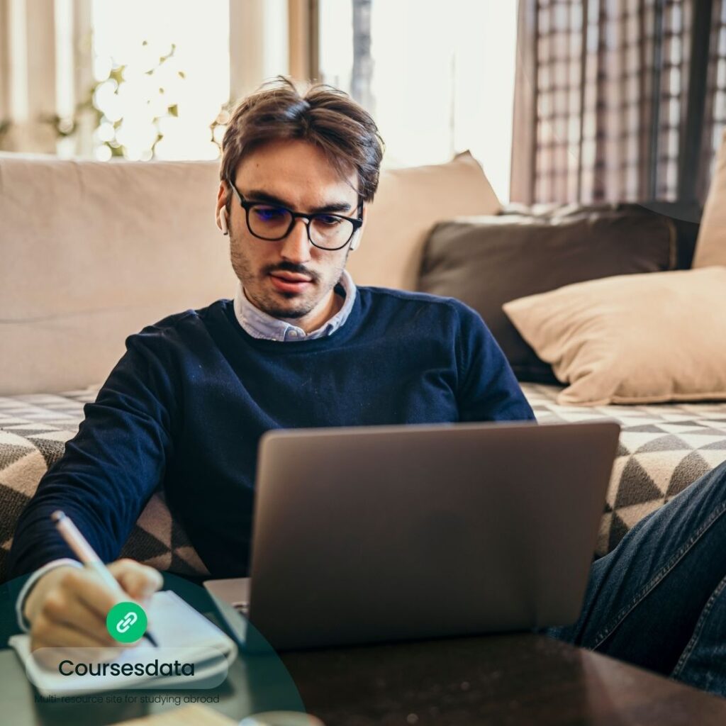 Young man studying on laptop.