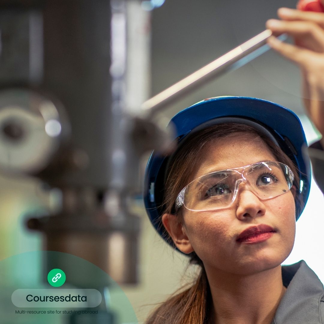 Woman in safety gear examining equipment.