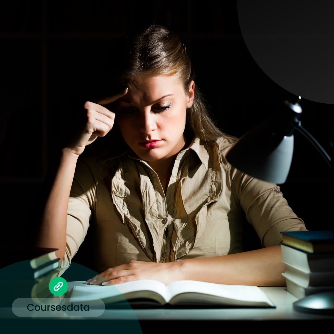 Woman studying under dim light.