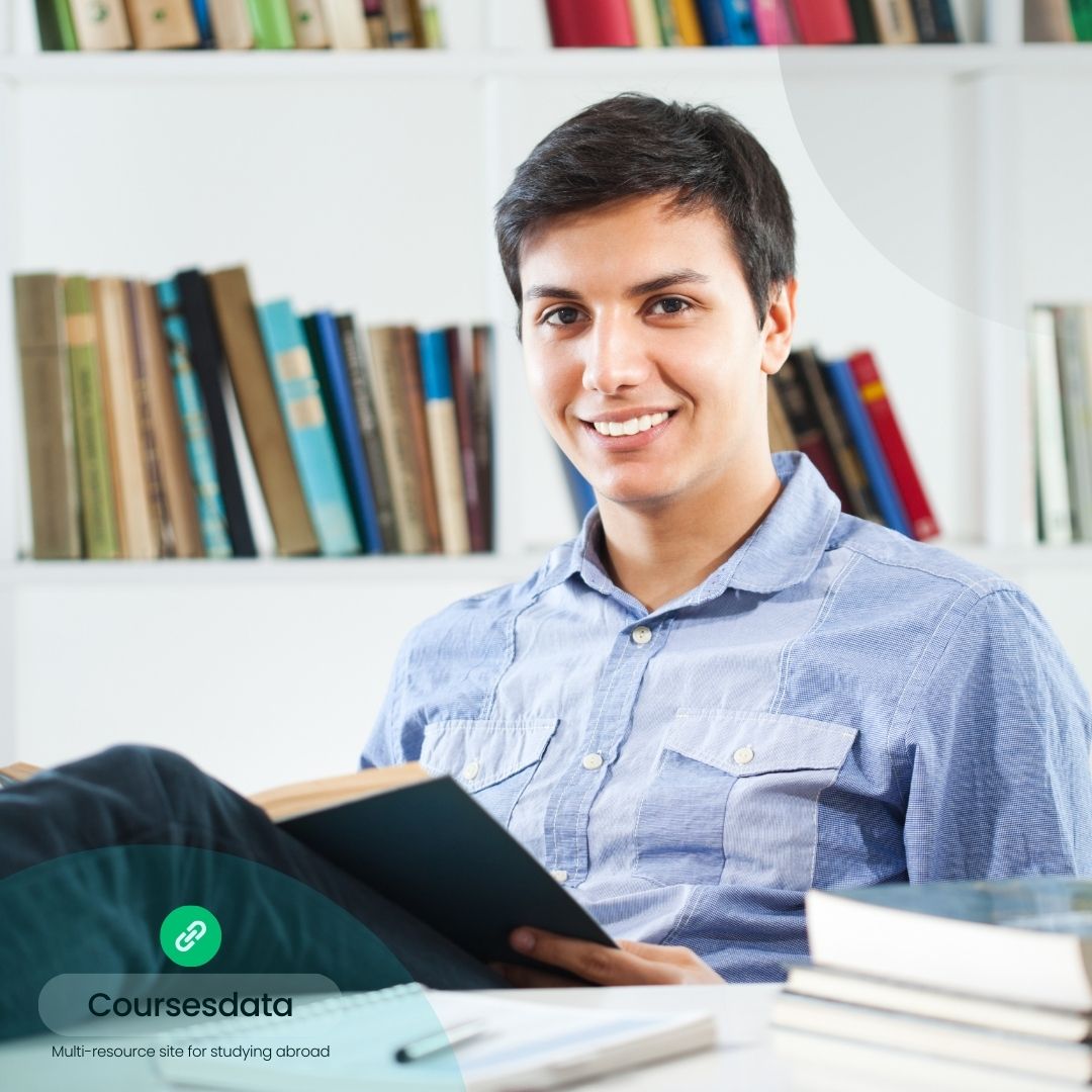 Smiling student reading book.