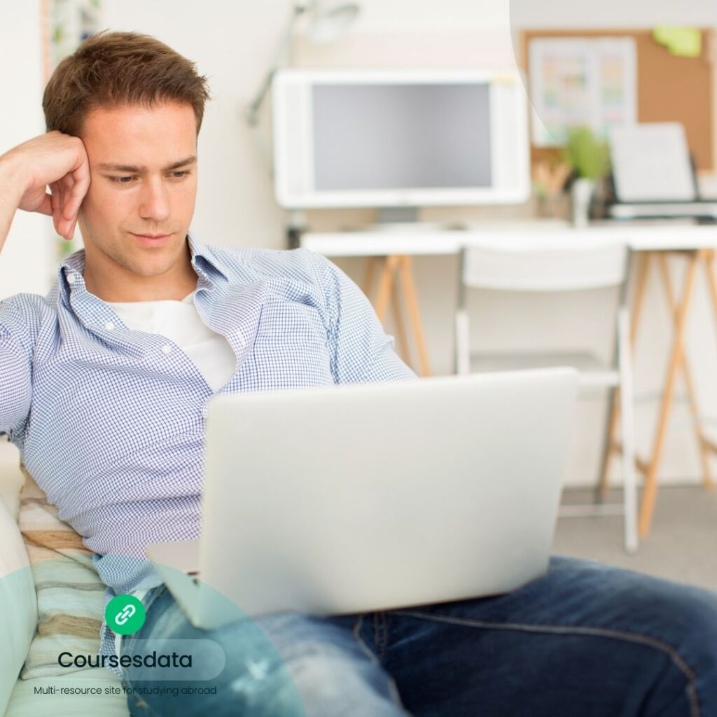 Man studying on laptop indoors.