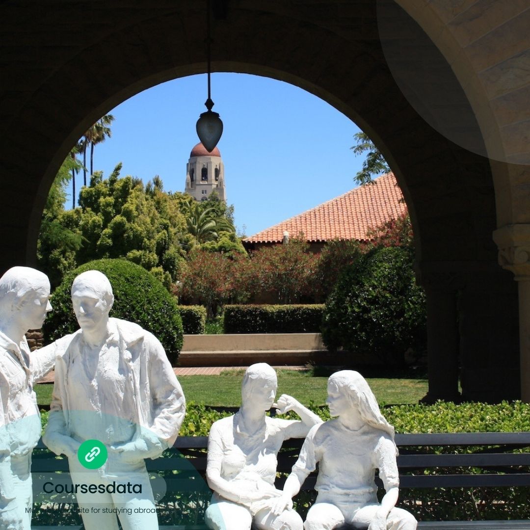 Sculptures under archway, garden view.