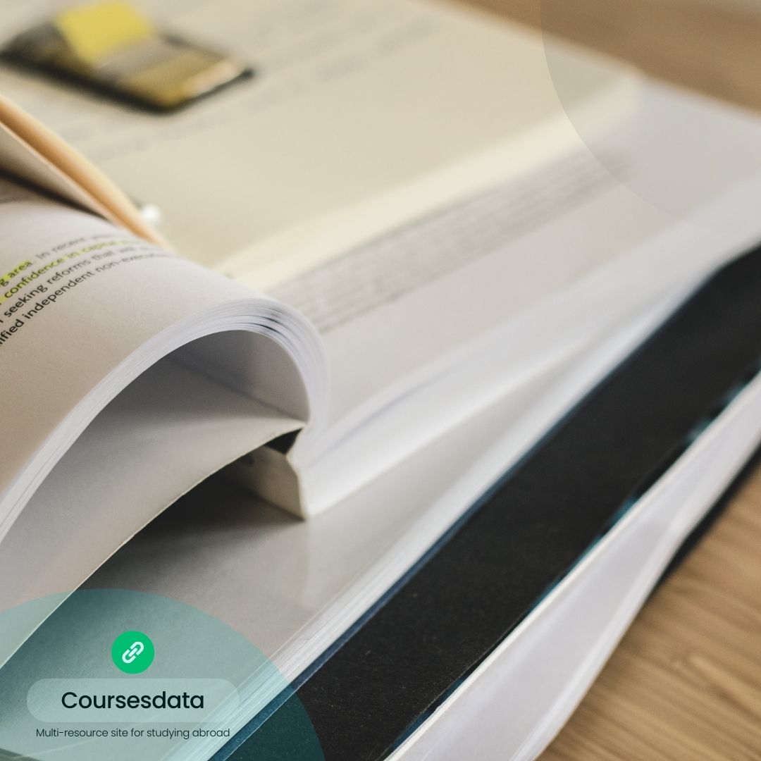 Stack of open study materials.